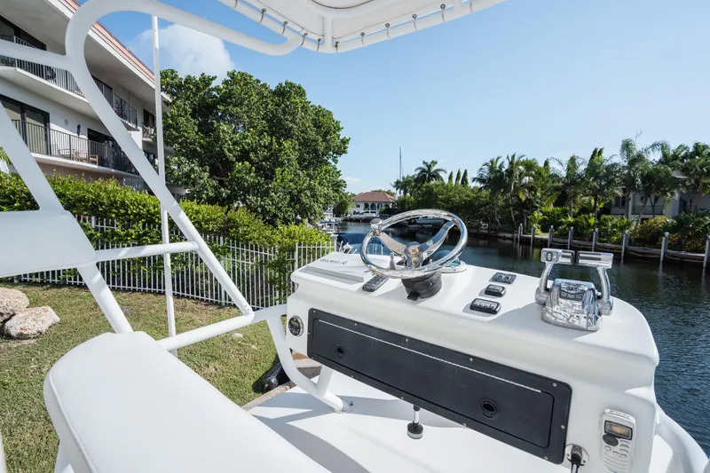  Yacht Photos Pics 2009 SeaHunter 40 boat helm with waterway and lush greenery in the background.