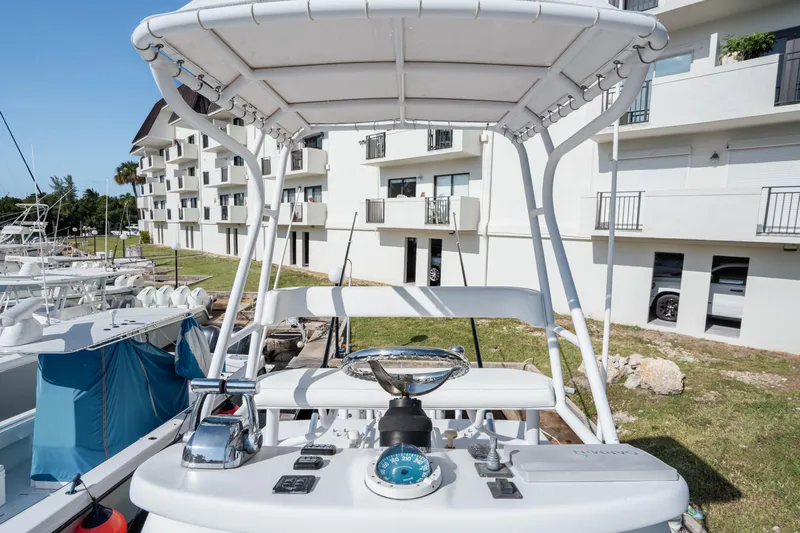 Yacht Photos Pics 2009 SeaHunter 40 boat helm with controls, docked near modern apartments.