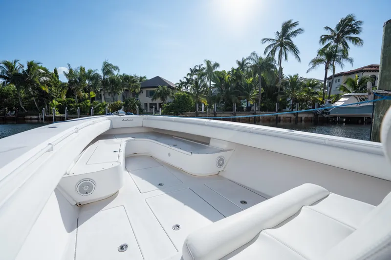  Yacht Photos Pics 2009 SeaHunter 40 boat with spacious deck, docked near tropical waterfront homes.