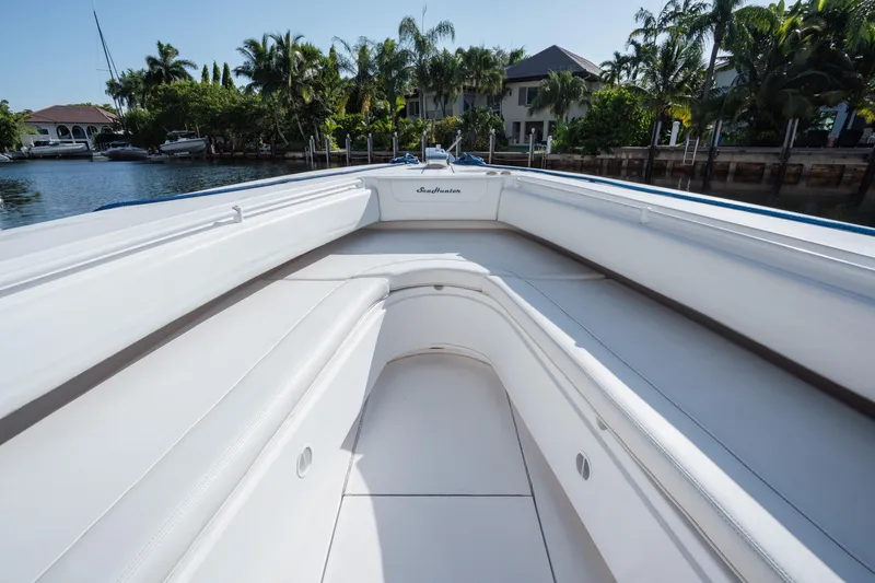  Yacht Photos Pics 2009 SeaHunter 40 boat interior with white seating, docked near waterfront homes.