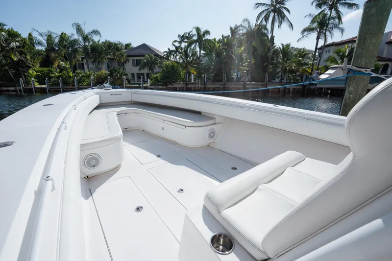  Yacht Photos Pics Luxurious 2009 SeaHunter 40 boat interior with white seating, docked near palm trees.