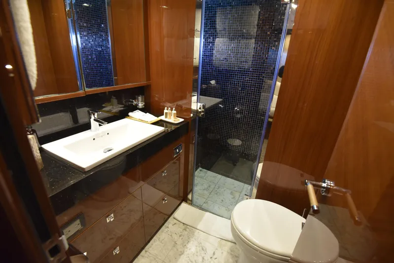 Princess One Yacht Photos Pics Luxurious bathroom in 2014 Princess Flybridge 98Y Motor Yacht with modern fixtures and elegant wood finishes.