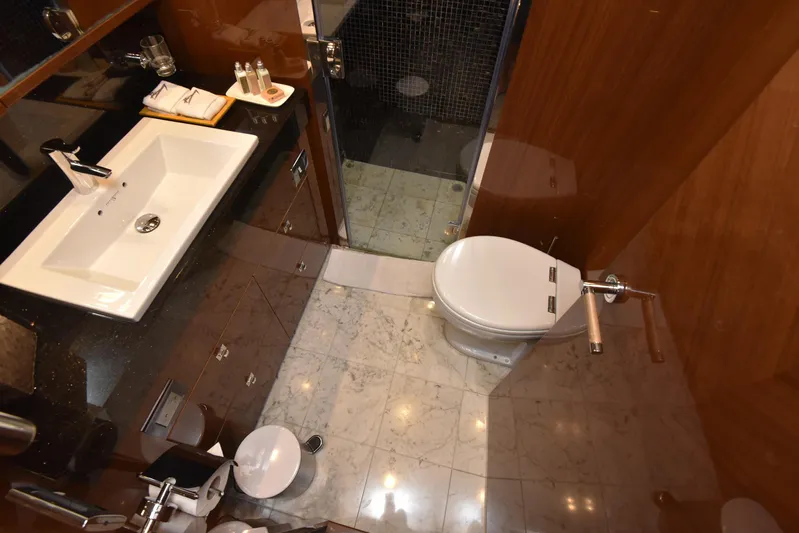 Princess One Yacht Photos Pics Luxurious bathroom in 2014 Princess Flybridge 98Y Motor Yacht with modern fixtures and marble flooring.
