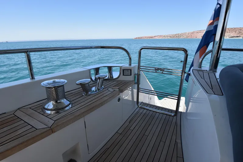 Princess One Yacht Photos Pics 2014 Princess Flybridge 98Y Motor Yacht deck with ocean view and flag.