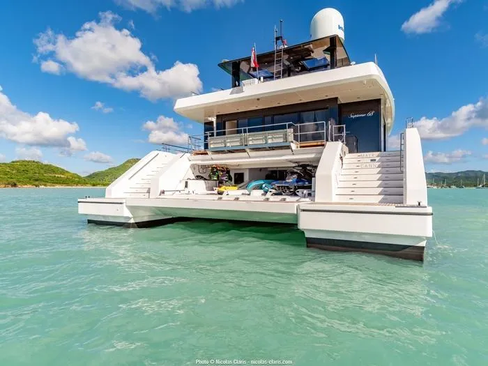 Rosa Del Mar Yacht Photos Pics 2017 Sunreef Supreme 68 yacht on turquoise water under a clear blue sky.