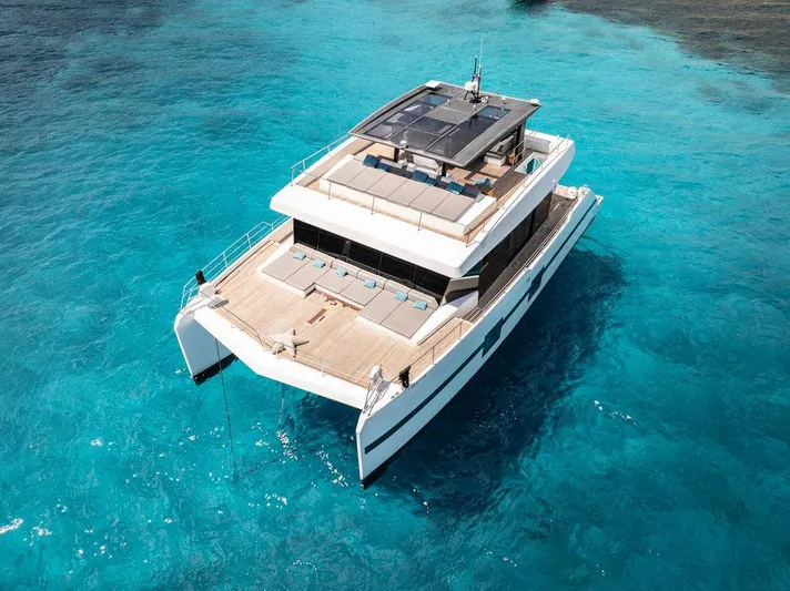 Rosa Del Mar Yacht Photos Pics Luxurious 2017 Sunreef Supreme 68 yacht on clear turquoise water.