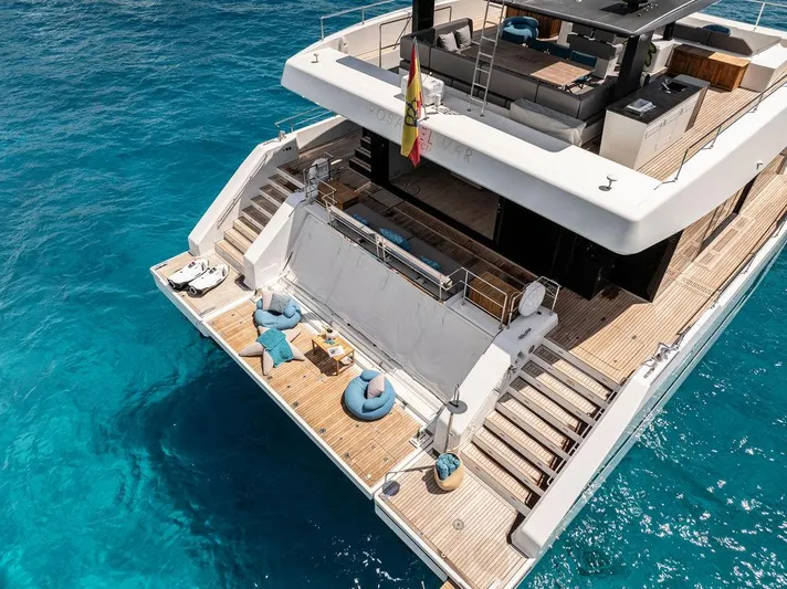 Rosa Del Mar Yacht Photos Pics Luxurious 2017 Sunreef Supreme 68 yacht on clear blue water, featuring spacious deck and seating.