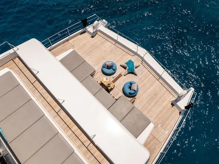 Rosa Del Mar Yacht Photos Pics Sunreef Supreme 68 yacht deck with seating, overlooking blue ocean waters, 2017 model.