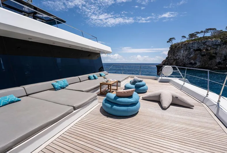 Rosa Del Mar Yacht Photos Pics Luxurious Sunreef Supreme 68 yacht deck with plush seating, ocean view, and clear skies.
