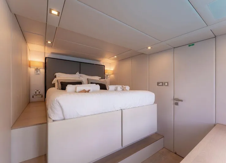 Rosa Del Mar Yacht Photos Pics Luxurious bedroom interior on 2017 Sunreef Supreme 68 yacht, featuring modern design and cozy lighting.