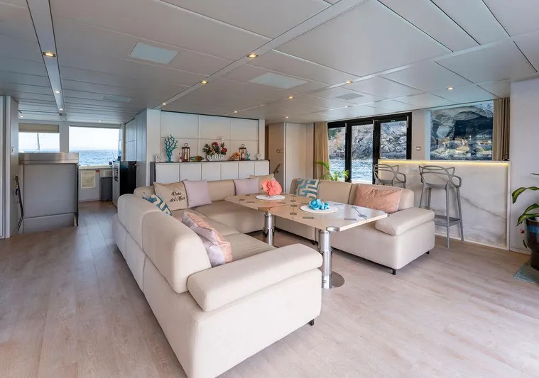 Rosa Del Mar Yacht Photos Pics Luxurious interior of 2017 Sunreef Supreme 68 yacht with modern furnishings and ocean view.