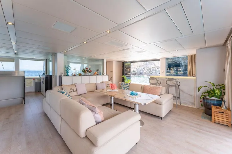 Rosa Del Mar Yacht Photos Pics Luxurious interior of 2017 Sunreef Supreme 68 yacht with modern furnishings and ocean view.