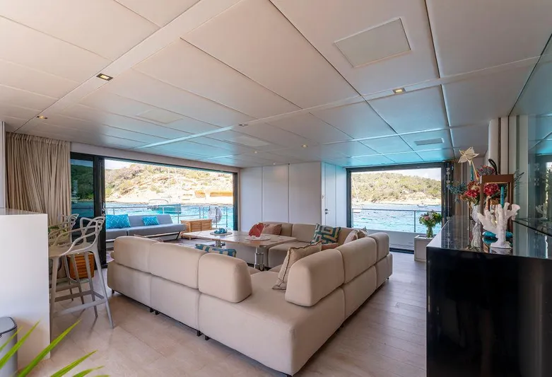 Rosa Del Mar Yacht Photos Pics Luxurious interior of 2017 Sunreef Supreme 68 yacht with spacious seating and scenic views.