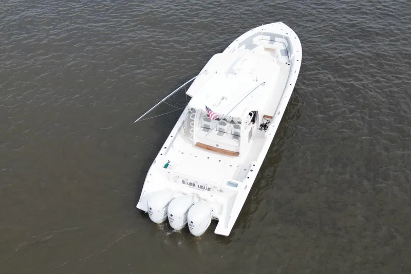  Yacht Photos Pics 2020 Pursuit S 408 Sport boat on water, aerial view, triple engines, American flag.