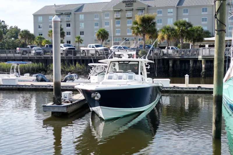  Yacht Photos Pics 2020 Pursuit S 408 Sport boat docked at marina near SpringHill Suites hotel.