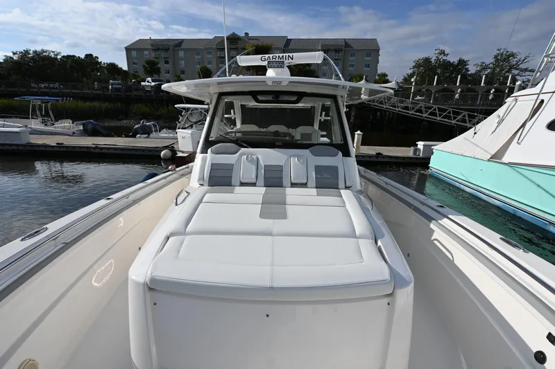  Yacht Photos Pics 2020 Pursuit S 408 Sport boat docked, featuring spacious seating and sleek design.