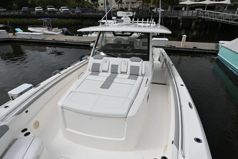  Yacht Photos Pics 2020 Pursuit S 408 Sport boat docked, featuring spacious seating and sleek design.