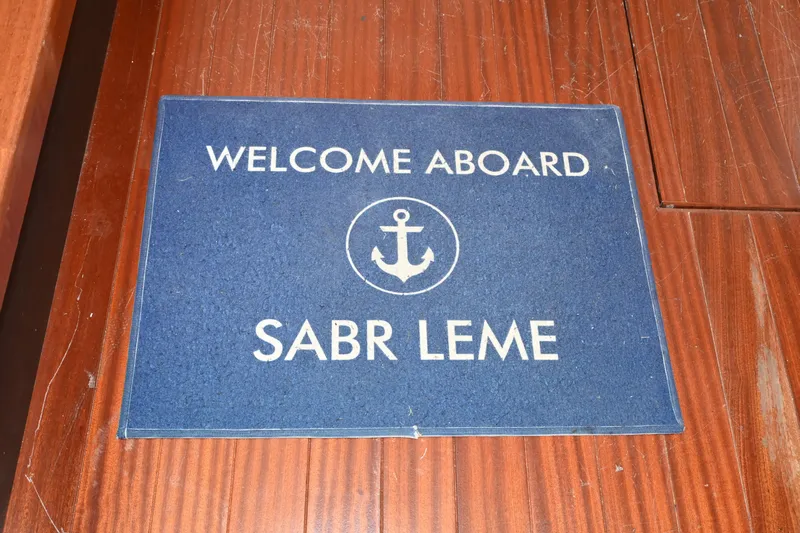  Yacht Photos Pics Welcome mat on 2020 Pursuit S 408 Sport boat, featuring anchor design.