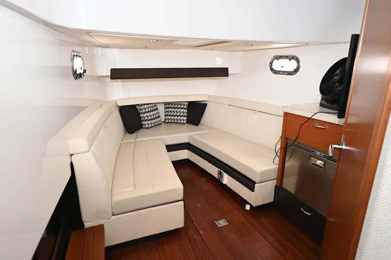  Yacht Photos Pics Luxurious interior of 2020 Pursuit S 408 Sport boat with beige seating and modern amenities.