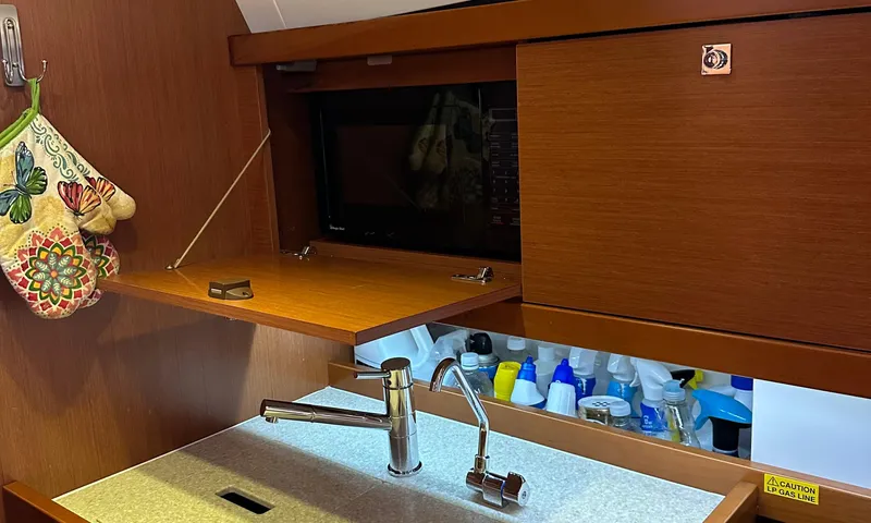 Lele Kalua Yacht Photos Pics Interior of 2014 Beneteau Oceanis 41 yacht kitchen with sink and microwave.