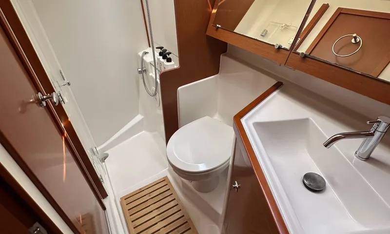 Lele Kalua Yacht Photos Pics Bathroom interior of 2014 Beneteau Oceanis 41 yacht, featuring shower, toilet, and sink.