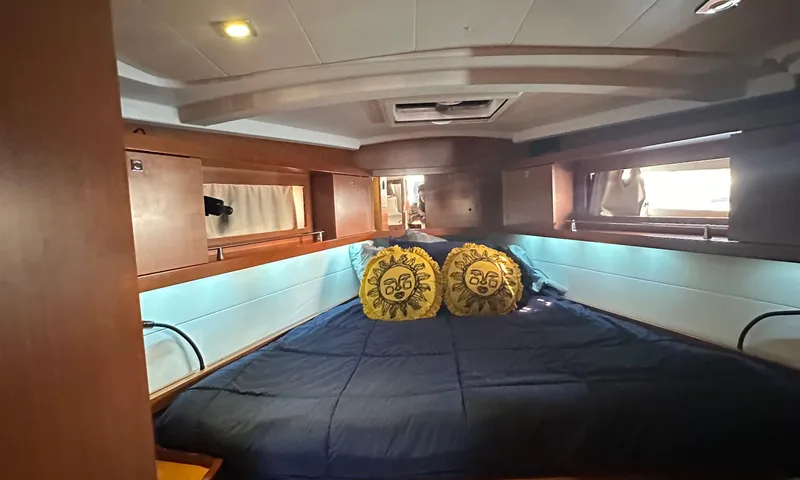 Lele Kalua Yacht Photos Pics Cozy cabin interior of 2014 Beneteau Oceanis 41 sailboat with double bed and decorative pillows.