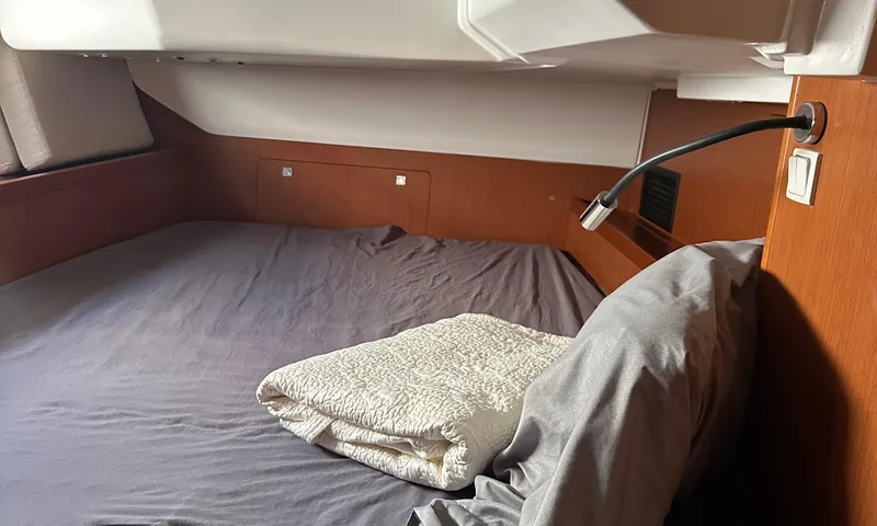 Lele Kalua Yacht Photos Pics Cozy cabin interior of 2014 Beneteau Oceanis 41 sailboat with bed and reading light.
