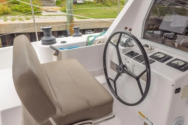 Honu Kai Yacht Photos Pics 2019 Seawind 1260 catamaran helm with steering wheel and navigation controls.