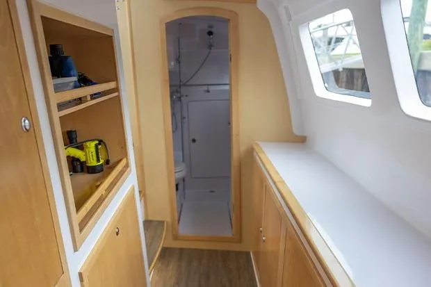 Honu Kai Yacht Photos Pics Interior of 2019 Seawind 1260 catamaran, featuring wooden cabinetry and a compact bathroom.