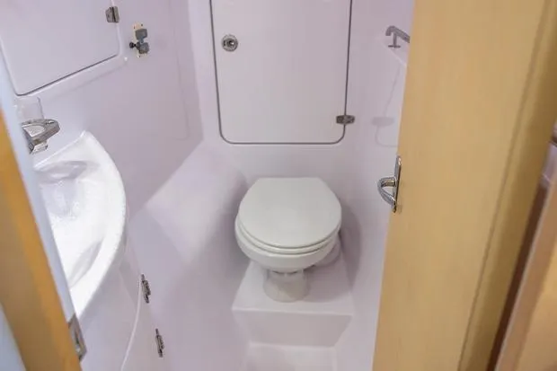 Honu Kai Yacht Photos Pics Compact bathroom in 2019 Seawind 1260 catamaran, featuring toilet and sink.