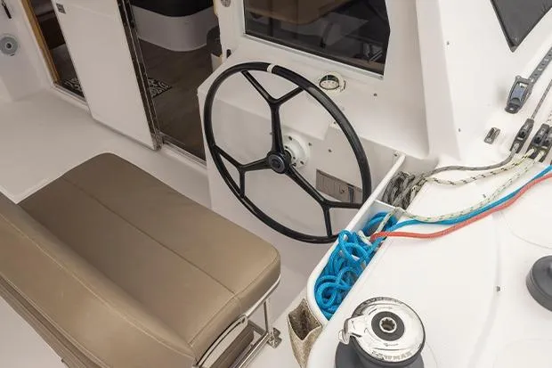 Honu Kai Yacht Photos Pics 2019 Seawind 1260 yacht cockpit with steering wheel and ropes.