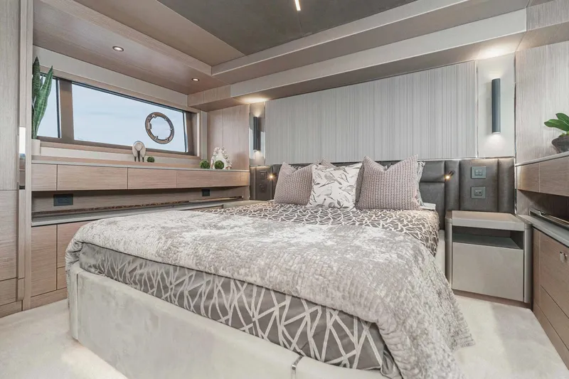  Yacht Photos Pics Luxurious bedroom interior of 2021 Sunseeker Manhattan 55 yacht, featuring modern design and elegant decor.