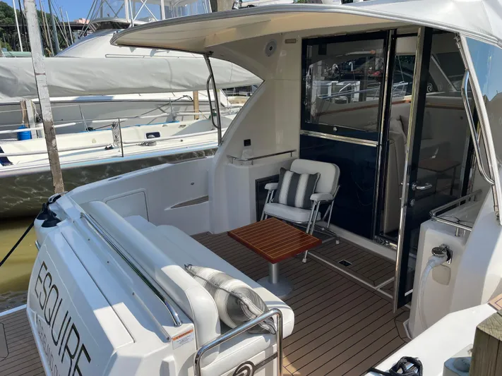 Esquire Yacht Photos Pics 2017 Riviera 3600 Sport Yacht with elegant outdoor seating and wooden table.