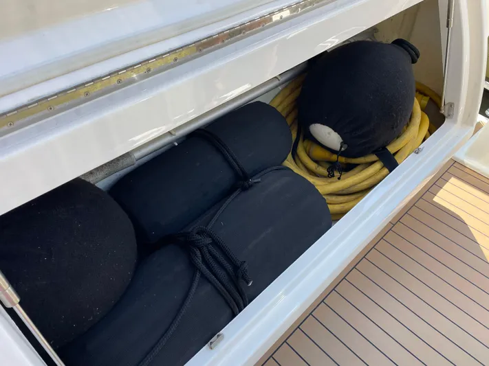 Esquire Yacht Photos Pics Storage compartment on 2017 Riviera 3600 Sport Yacht with fenders and coiled hose.