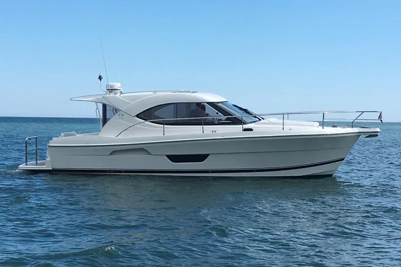 Esquire Yacht Photos Pics 2017 Riviera 3600 Sport Yacht cruising on calm blue waters.