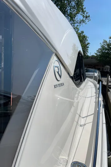 Esquire Yacht Photos Pics 2017 Riviera 3600 Sport Yacht, sleek design, docked under clear blue sky.