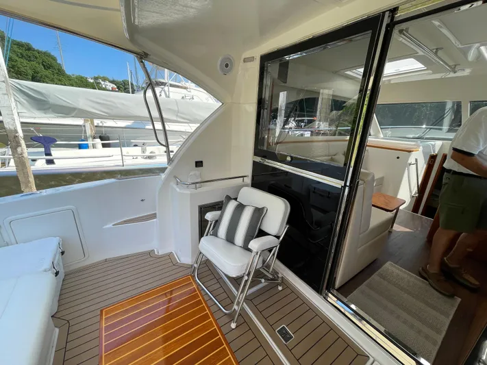 Esquire Yacht Photos Pics 2017 Riviera 3600 Sport Yacht interior with seating and wooden flooring.