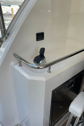 Esquire Yacht Photos Pics 2017 Riviera 3600 Sport Yacht interior with control panel and seating.