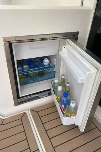 Esquire Yacht Photos Pics Open mini fridge on 2017 Riviera 3600 Sport Yacht, stocked with beverages.