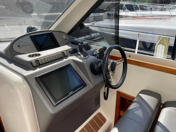 Esquire Yacht Photos Pics 2017 Riviera 3600 Sport Yacht helm with modern controls and navigation screens.