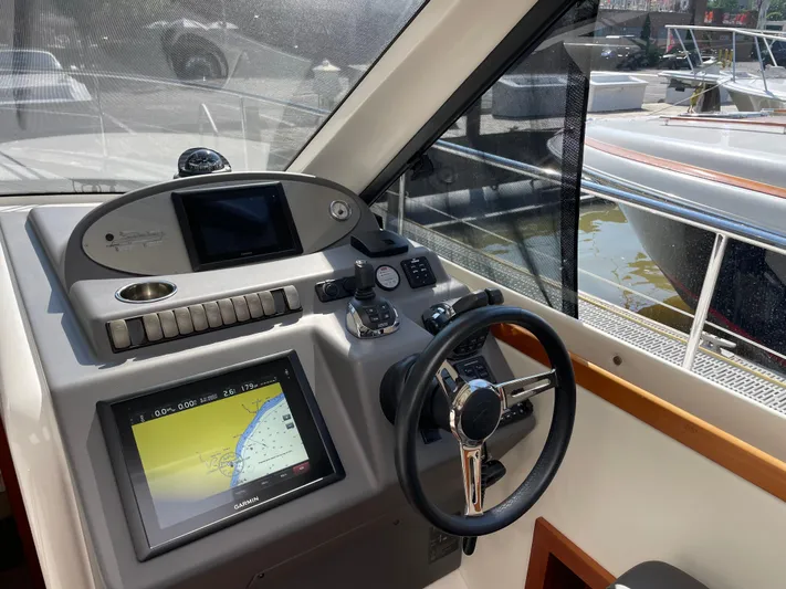 Esquire Yacht Photos Pics Helm of 2017 Riviera 3600 Sport Yacht with navigation system and steering wheel.