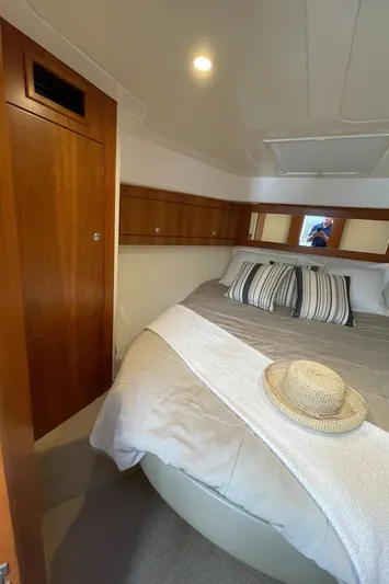 Esquire Yacht Photos Pics Luxurious cabin interior of 2017 Riviera 3600 Sport Yacht with cozy bed and elegant wood finish.