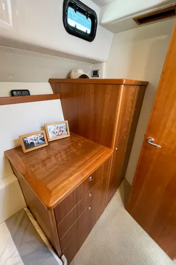 Esquire Yacht Photos Pics Interior of 2017 Riviera 3600 Sport Yacht with wooden cabinetry and framed photos.