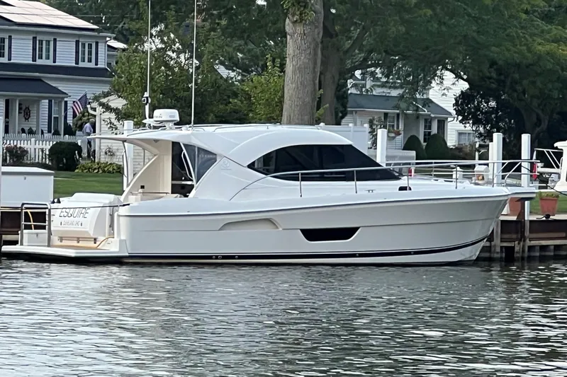 Esquire Yacht Photos Pics 2017 Riviera 3600 Sport Yacht docked by waterfront homes.