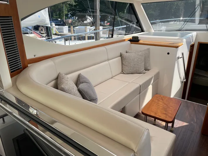 Esquire Yacht Photos Pics Luxurious interior of 2017 Riviera 3600 Sport Yacht with plush seating and wooden accents.