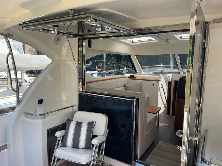 Esquire Yacht Photos Pics 2017 Riviera 3600 Sport Yacht interior with seating and modern design elements.