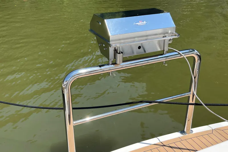 Esquire Yacht Photos Pics Stainless steel grill on 2017 Riviera 3600 Sport Yacht, overlooking calm green water.