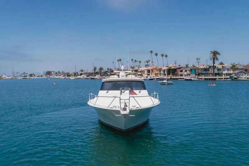 Endurance Yacht Photos Pics 2008 Viking 52 Sport Coupe yacht cruising in a scenic harbor with waterfront homes.