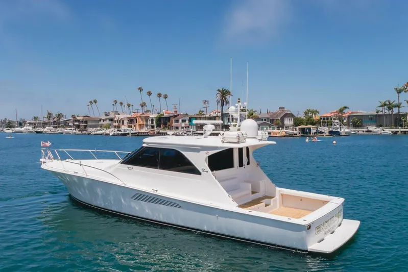 Endurance Yacht Photos Pics 2008 Viking 52 Sport Coupe yacht cruising in a scenic harbor with waterfront homes.