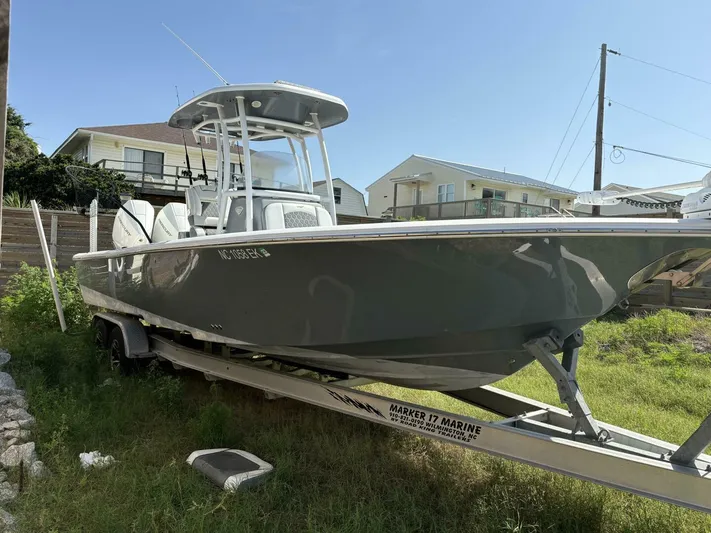  Yacht Photos Pics 2019 Tidewater 2700 Carolina Bay boat on trailer, parked outdoors near houses.